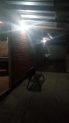 a dark room with a table and a light at Cabañas doña chiche in San Lorenzo