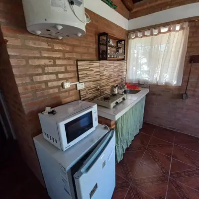 a kitchen with a microwave and a sink at Cabañas doña chiche in San Lorenzo