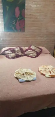 a bed with two towels on top of it at Cabañas doña chiche in San Lorenzo