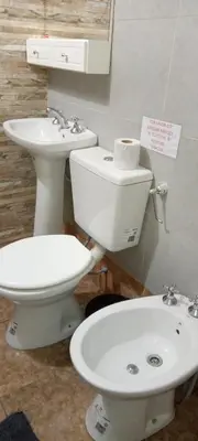 a bathroom with a toilet and a sink at Cabañas doña chiche in San Lorenzo