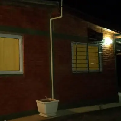 a toilet sitting outside of a brick building at night at Cabañas doña chiche in San Lorenzo