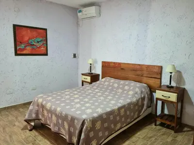 a bedroom with a bed and two night stands with lamps at Finca La Hermosa in San Javier