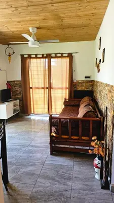 a bedroom with a wooden bed in a room at La Bonita, casa en alquiler frente al lago in La Estancia