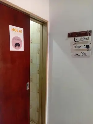 a door to a bathroom with a sign on the wall at Alquimia Dos in Cordoba