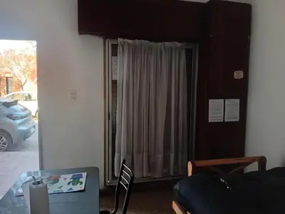 a living room with a table and a sliding glass door at Alquimia Dos in Cordoba