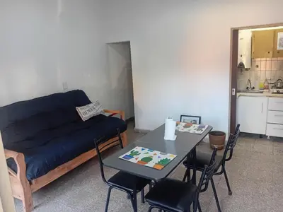 a living room with a blue couch and a table at Alquimia Dos in Cordoba