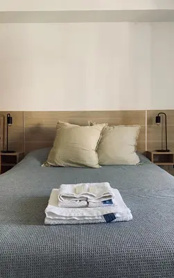 a bed with a pile of towels on it at Urban 362 in Cordoba