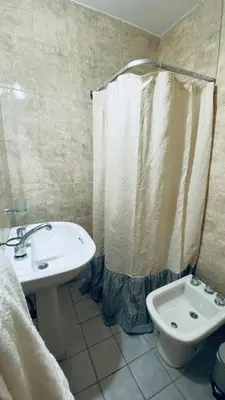 a bathroom with a sink and a toilet and a shower curtain at Urban 362 in Cordoba