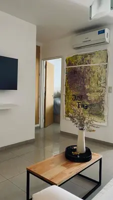 a living room with a vase on a table at Urban 362 in Cordoba