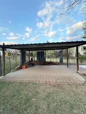a pavilion with a black covering on a field at Posada Don Ramón in Estancia Vieja