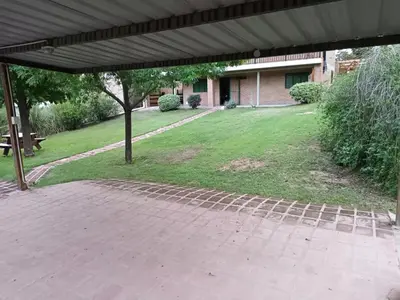a brick patio with a pavilion in a yard at Posada Don Ramón in Estancia Vieja