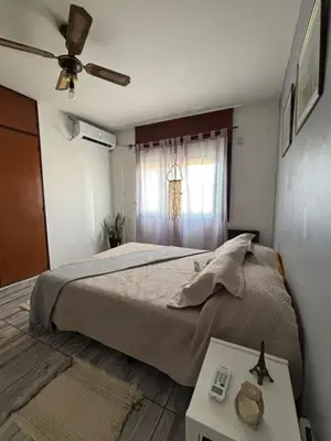 a bedroom with a large bed and a window at Depto en pleno centro Villa Carlos Paz in Villa Carlos Paz