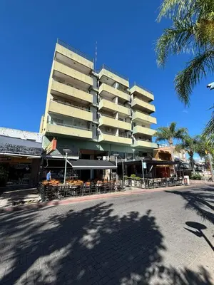 a large building with tables and chairs in front of it at Depto en pleno centro Villa Carlos Paz in Villa Carlos Paz