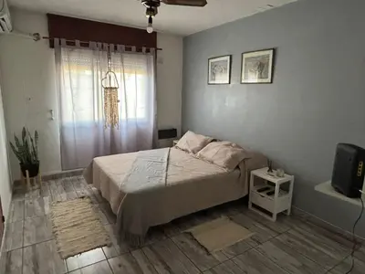 a bedroom with a bed and a television in it at Depto en pleno centro Villa Carlos Paz in Villa Carlos Paz