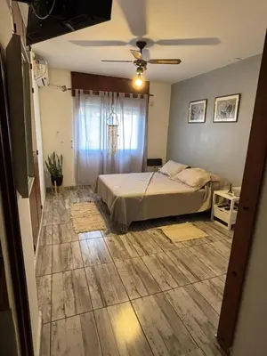 a bedroom with a bed and a ceiling fan at Depto en pleno centro Villa Carlos Paz in Villa Carlos Paz