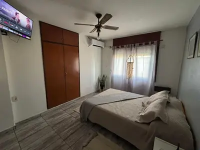 a bedroom with a bed and a ceiling fan at Depto en pleno centro Villa Carlos Paz in Villa Carlos Paz