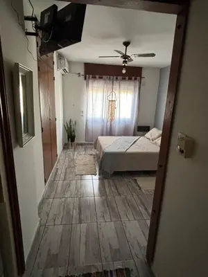 a bedroom with a bed and a ceiling fan at Depto en pleno centro Villa Carlos Paz in Villa Carlos Paz