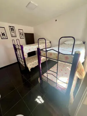 a room with two bunk beds in a room at Jacarandá in Villa Carlos Paz