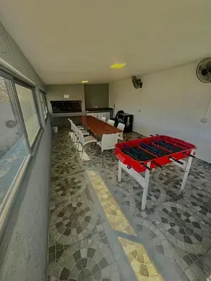 a room with a ping pong table and chairs at Jacarandá in Villa Carlos Paz
