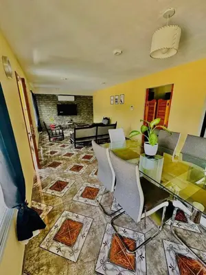a living room with a table and chairs at Jacarandá in Villa Carlos Paz