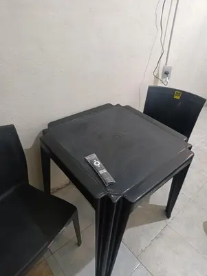 a black table and chair with a laptop on it at Cabrales in Cordoba