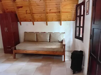 a couch in a room with a wooden ceiling at Alpinas El Chusmo 3 in Villa Ciudad Parque