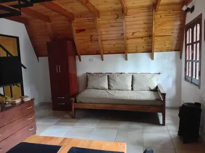 a living room with a couch and wooden ceilings at Alpinas El Chusmo 3 in Villa Ciudad Parque
