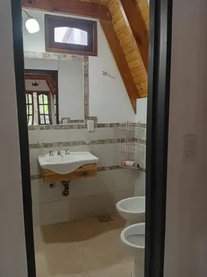a bathroom with a sink and a toilet at Alpinas El Chusmo 3 in Villa Ciudad Parque