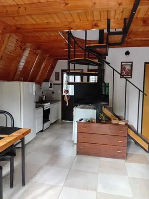 a kitchen with wooden ceilings and a dining room at Alpinas El Chusmo 3 in Villa Ciudad Parque