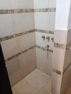 a bathroom with a shower with a tiled shower at Alpinas El Chusmo 3 in Villa Ciudad Parque