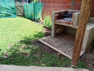 a beehive in a yard with a fence at Alpinas El Chusmo 3 in Villa Ciudad Parque