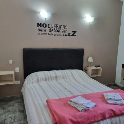 a bedroom with a bed with two towels on it at Brisas del sol in Villa Carlos Paz