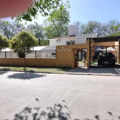 a building with a fence in front of it at Brisas del sol in Villa Carlos Paz
