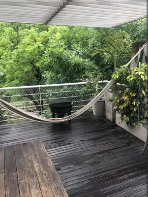 a porch with a hammock and a bench on a deck at Dto lujoso in Cordoba