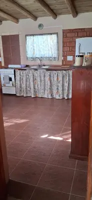 a kitchen with a tile floor and a window at El rancho de cristina y victor in Arroyo de Los Patos