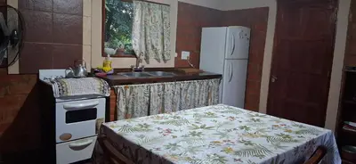 a small kitchen with a sink and a refrigerator at El rancho de cristina y victor in Arroyo de Los Patos
