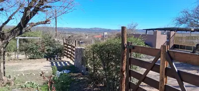 a wooden fence in front of a house at El rancho de cristina y victor in Arroyo de Los Patos