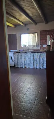 a kitchen with a table and a window in a room at El rancho de cristina y victor in Arroyo de Los Patos