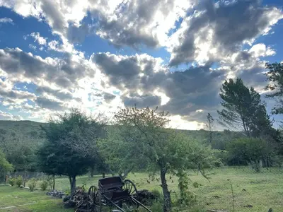 a group of bikes parked in a field under a cloudy sky at Cabaña Don Americo in Villa García