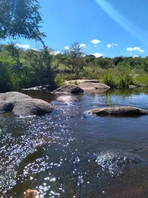 a river with rocks in the middle of it at Cabaña Don Americo in Villa García
