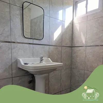a bathroom with a sink and a mirror at Cabaña Don Americo in Villa García