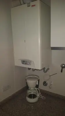 a bathroom with a toilet in the corner of a room at Apartment Nueva Córdoba in Cordoba