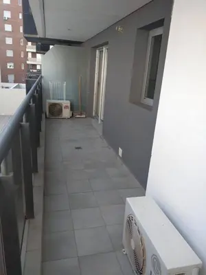 a hallway of a room with a fan on the floor at Apartment Nueva Córdoba in Cordoba