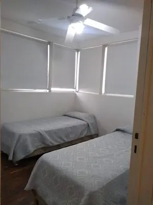 a room with two beds and a ceiling fan at Apartment Nueva Córdoba in Cordoba