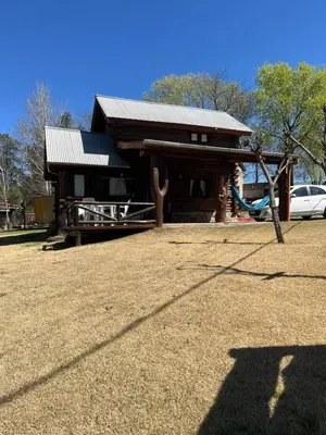 a small house with a playground in front of it at Cabañas Fénix de Los Reartes in Los Reartes