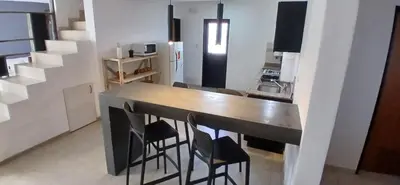 a kitchen with a table and chairs in a room at Alojamiento ideal en zona norte de Córdoba Capital in Cordoba