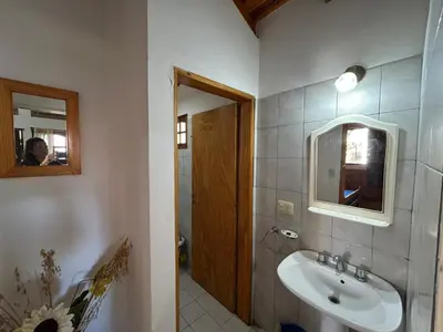 a bathroom with a sink and a mirror at La Hormiga in Santa Rosa de Calamuchita