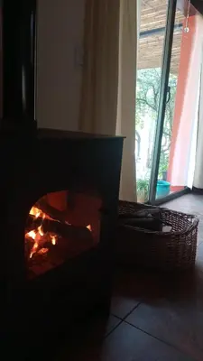 a fireplace in a room next to a window at La Casa De Mi Viejo in San Javier