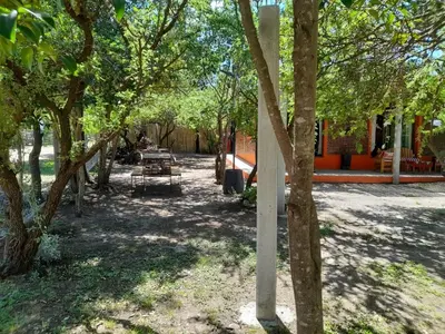 a park with tables and trees in the shade at La Casa De Mi Viejo in San Javier