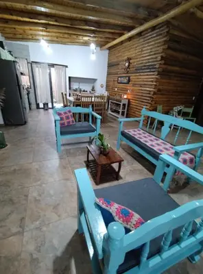 a living room with blue chairs and a table at La Casa De Mi Viejo in San Javier